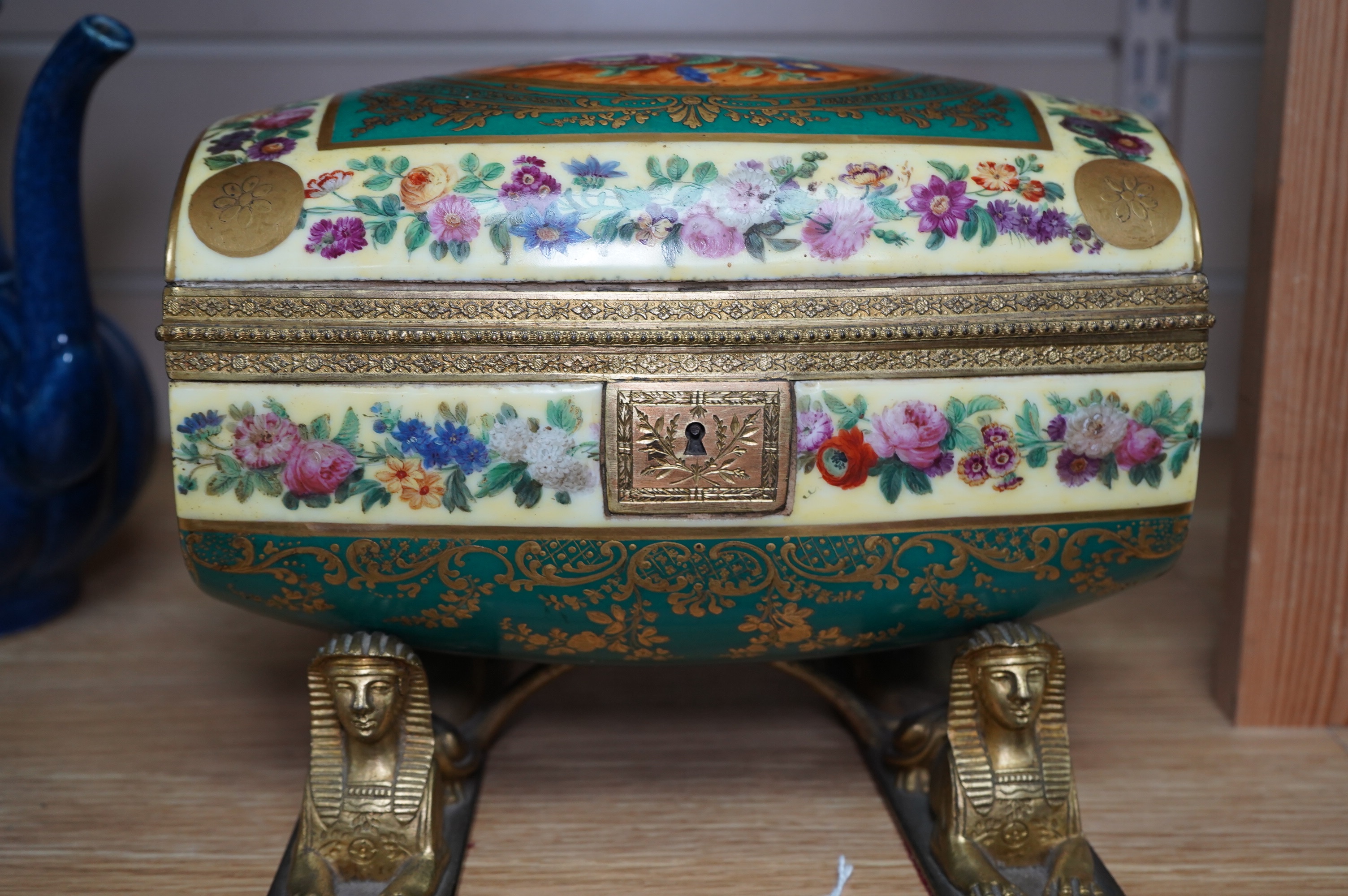 An early 20th century Sevres style sarcophagus shaped casket, on twin sphinx ormolu base, 24cm. Condition - good